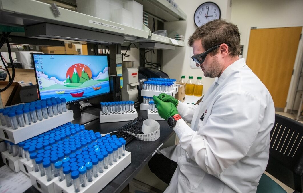 Nick Nabours, a research technician with DNASU Plasmid Repository, affixes bar code labels to test tubes that will be used in testing for COVID-19, at Biodesign A, on Monday, March 30, 2020. (Photo by Charlie Leight/ASU Now)